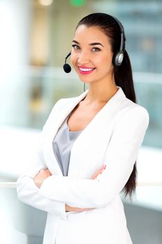 Closeup portrait of support phone operator in headset at workplace in the office