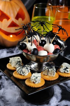 buffet   snack of cracker with blue cheese and bowl  baby salami, mozzarella, olives on the table in honor of Halloween