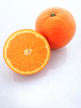 Fresh orange and slices on white background.