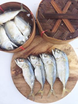 short mackerel on cutting board with fish basket