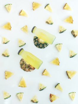 Fresh and cold pineapple drink among triangular piece of pineapple