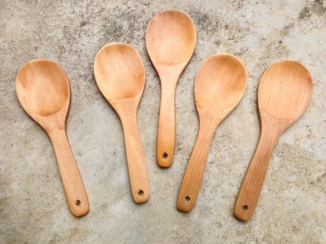 Wooden ladle on cement background