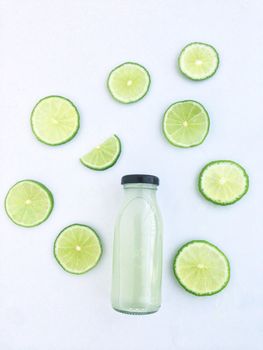 Bottle of lime drinks and Cut into wedges, white background