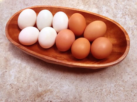 Eggs on wooden bowl