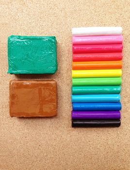 Clay palettes on plywood background. Rainbow colors