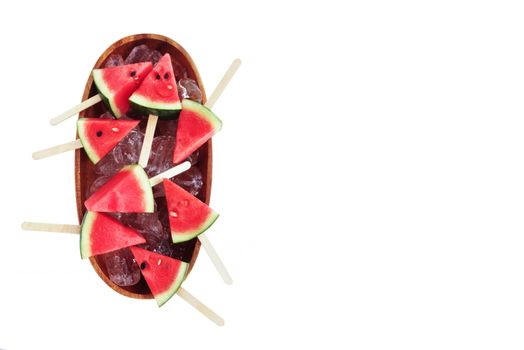 Watermelon slice popsicles in ice wooden bowl on white background