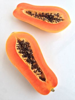 slices of sweet papaya on white background