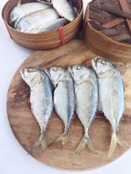 short mackerel on cutting board with fish basket