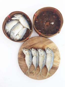 short mackerel on cutting board with fish basket