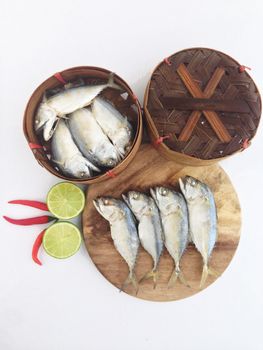 short mackerel on cutting board with fish basket