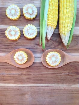 Corn on wooden background