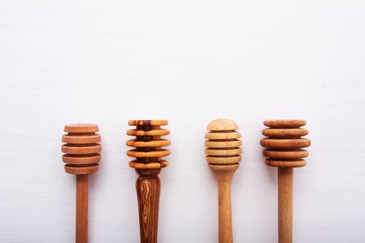 wooden honey stick isolated on white wooden background, Top view with copy space.