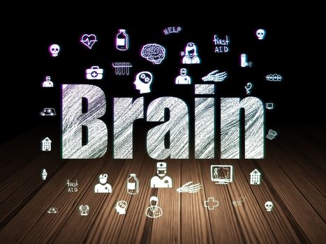 Health concept: Glowing text Brain,  Hand Drawn Medicine Icons in grunge dark room with Wooden Floor, black background
