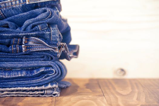 Stack Of Jeans On Old Wood Flooring, Fashion Concept 