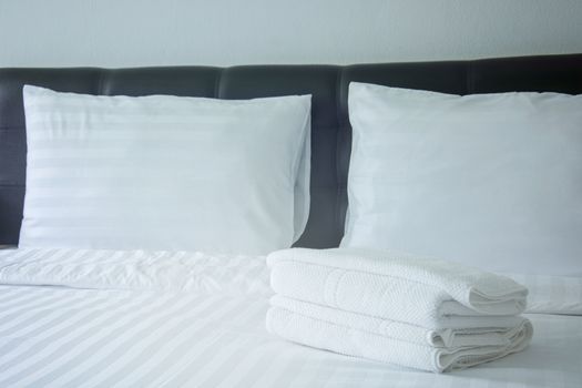 white pillow and blanket with wrinkle messy on bed in bedroom with lighting upper left side, from sleeping in a long night winter.