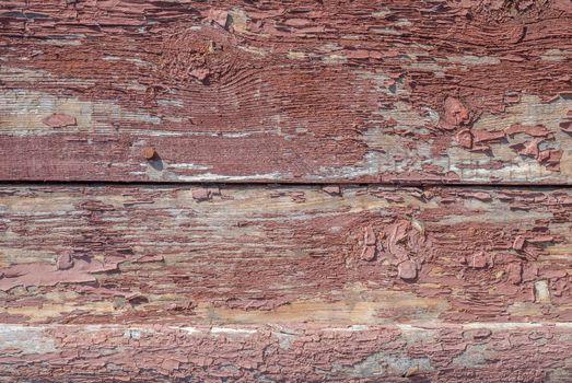 texture of wooden surface with remnants of old paint that has dried and cracked under the influence of weather