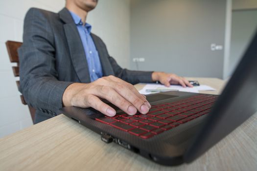 Business man working  with laptop and documents on wood table