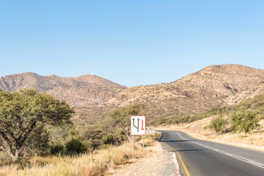 Looking South on the B1-road to the South of Windhoek, the capital city of Namibia. A microwave telecommunications tower is visible on Grossherzog Friedrich Mountain