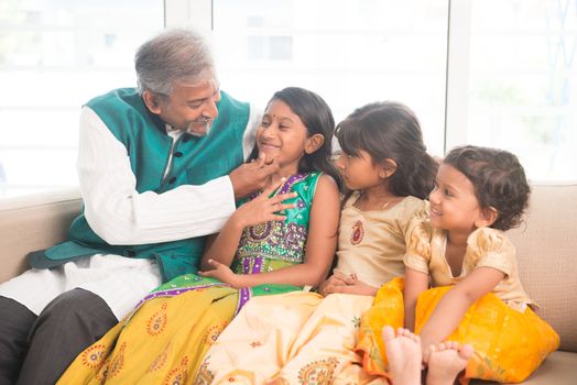 Portrait of happy Indian family having fun at home. Asian father and children indoors lifestyle.