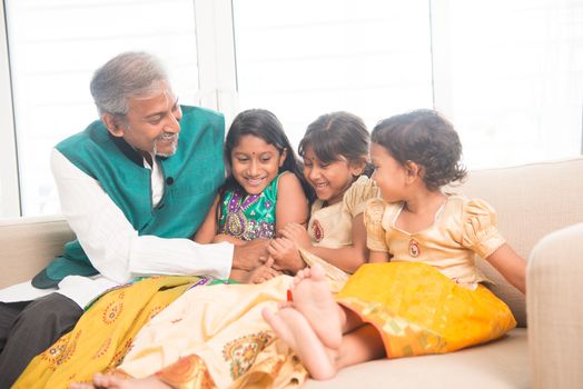 Portrait of happy Indian family playing at home. Asian father and children indoors lifestyle.