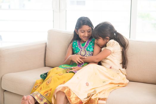 Portrait of Indian family playing at home. Happy Asian children indoors lifestyle.