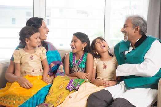 Portrait of happy Indian family bonding at home. 