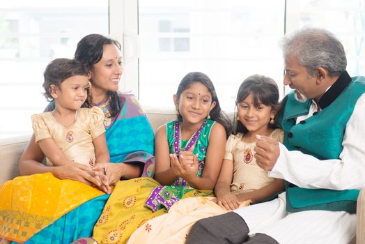 Portrait of happy Indian family relax at home. Asian people indoors lifestyle.