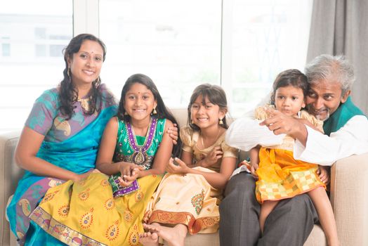 Portrait of happy Indian family of five at home. Asian people indoors lifestyle.