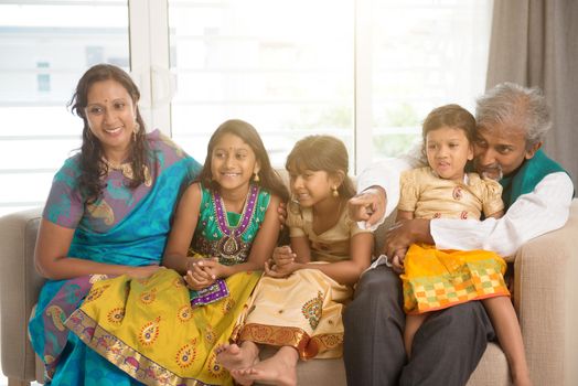 Portrait of happy Indian family at home. Asian people indoors lifestyle.