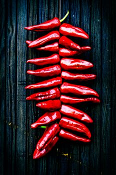 String of Espelette peppers hanging to dry on a wooden door