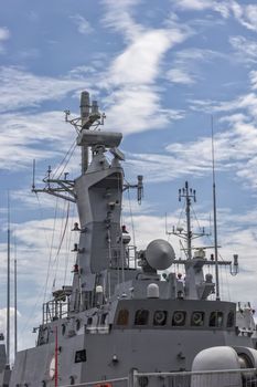 A part of military navy ship. Military sea landscape with cloudy sky