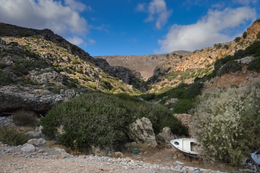 View in the mountains west of Crete with an old boat sleeping on the ground