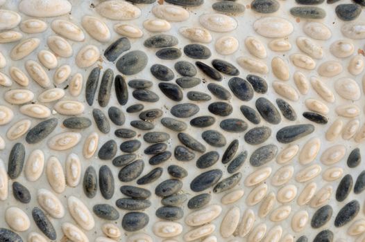 Mosaic of a vine leaf with white and black pebbles in a Cretan monastery