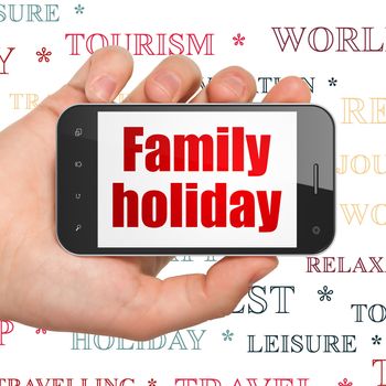 Travel concept: Hand Holding Smartphone with  red text Family Holiday on display,  Tag Cloud background, 3D rendering