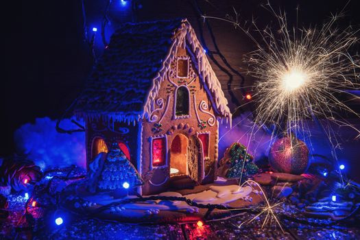 Gingerbread house with lights on dark background, xmas theme