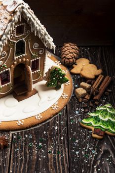 Gingerbread house with lights on dark background, xmas theme