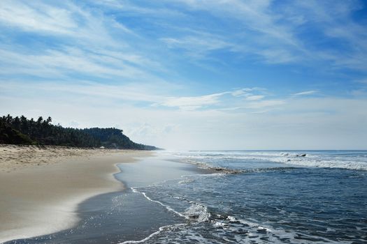 
The ocean beach is in the horizon with small waves and haze.