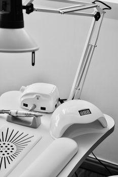 Nails uv lamp and cosmetics stuff in beauty salon. Lamp and machines concept.