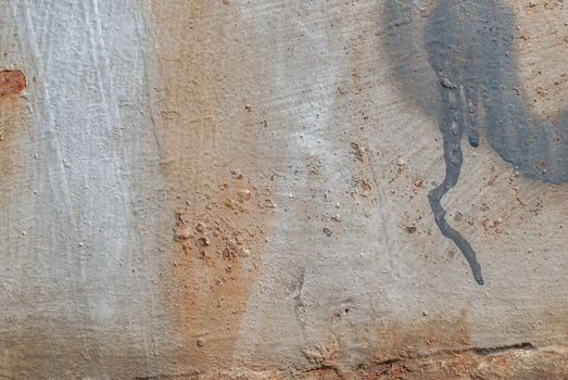 rusty iron surface covered with old chipped grey color paint, which has long been influenced by different climatic conditions