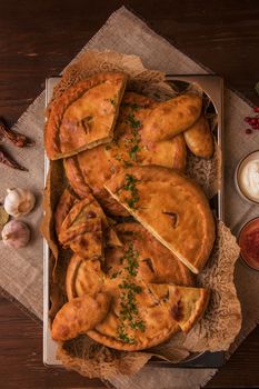 Different pies from meat and vegetables. Freshly baked cakes on a table