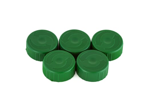 Five green plastic bottle caps isolated on white