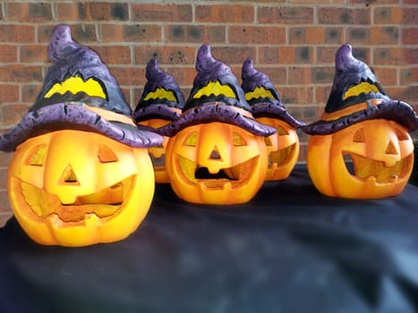 smiled pumpkins for halloween in blue hat