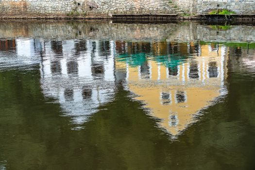 Reflection of Colourful Buildings along the Vlatava River in Krumlov