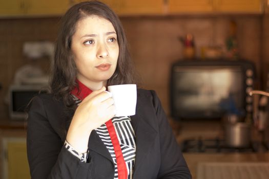 beautiful muslim young business woman hold cup of coffee in kitchen and dreaming