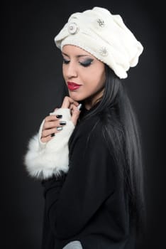 Winter portrait of a young romantics woman in a white hat and gloves