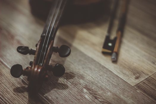 Vintage old violin lying on a wooden surface