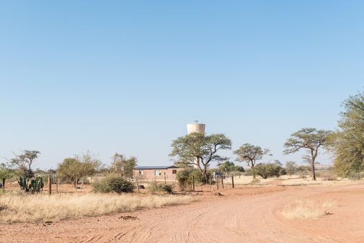 A street scene with a house and water reservoir in Koes, a small town in the Karas Region in Namibia