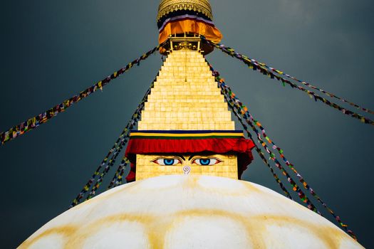 Boudhanath stupa in Kathmandu, Nepal. Stormy clouds in the background.