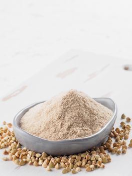 Buckwheat flour and buckwheat on white background Copy space.