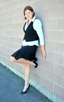 Female nanny in uniform taking a break outside.